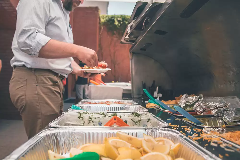 A man enjoying a catered feast at a party